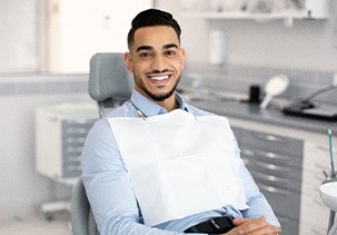 Patient smiling while sitting in treatment chair