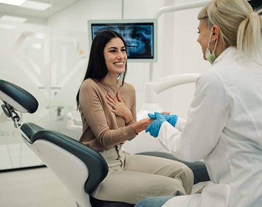 A woman chatting with her dentist before a checkup