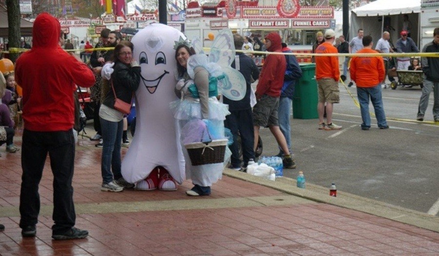 Community residents taking picture with tooth mascot at Chardon Maple Festival