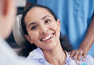 a smiling woman talking to her dentist