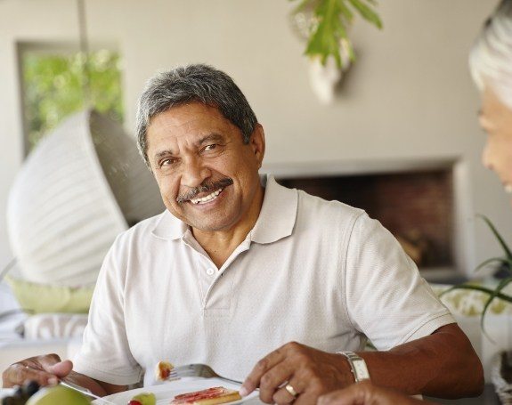 Man smiling and enjoying the benefits of dental implants