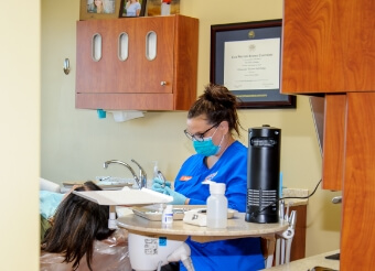 Dental team member treating patient