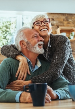 Man and woman smiling after restorative dentistry