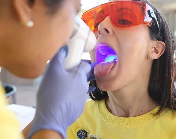 Dentist performing oral cancer screening