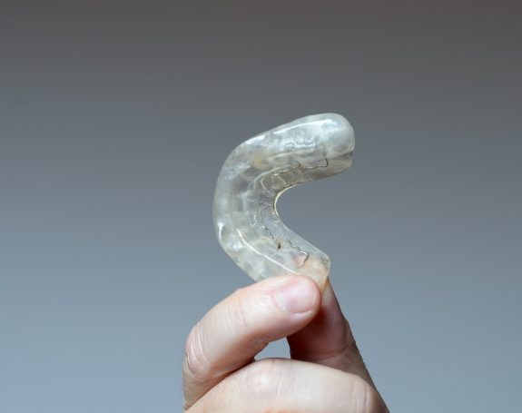 Hand holding a nightguard for bruxism