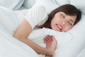 A patient with bruxism trying to sleep